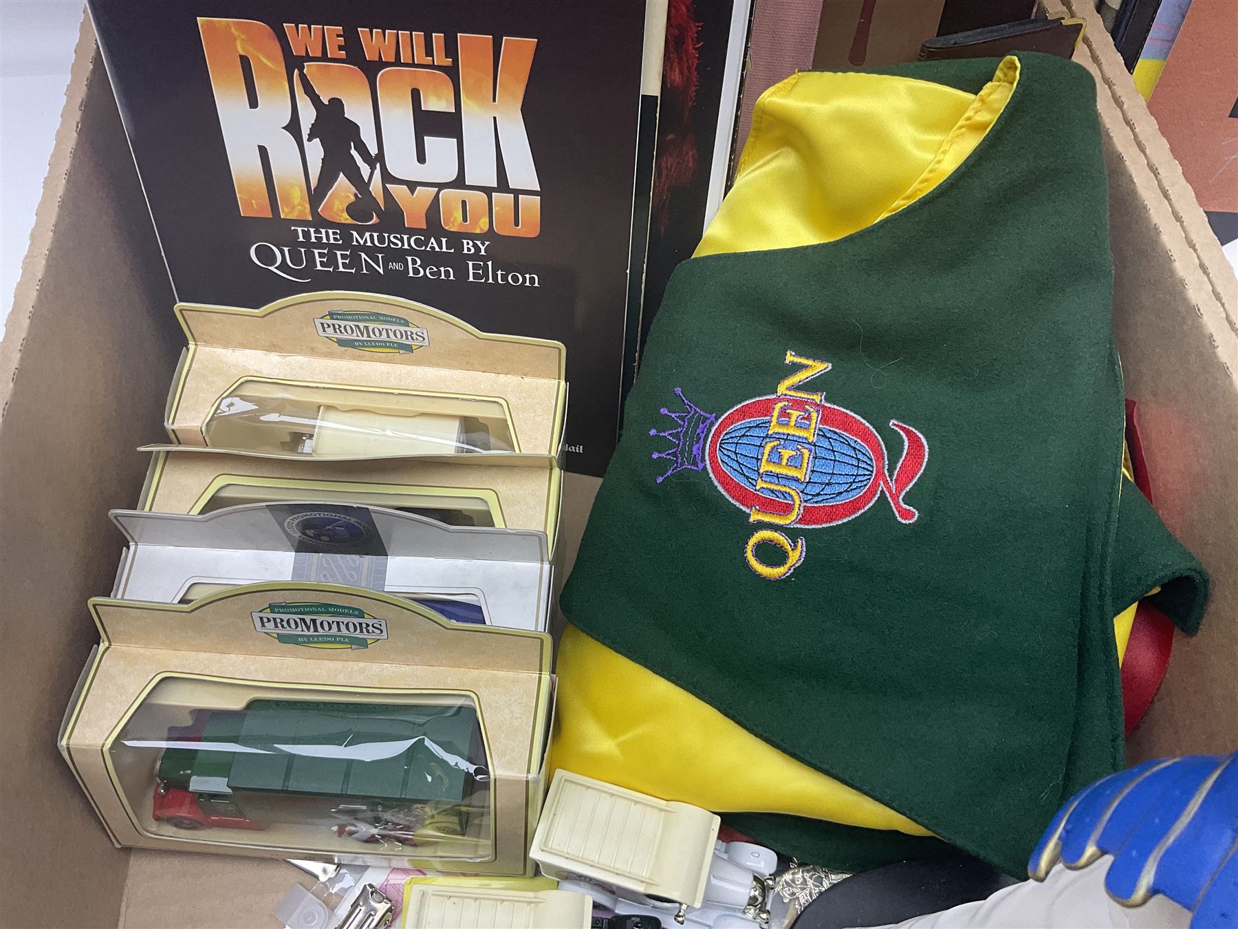 Mostly Queen and Freddie Mercury interest items, including pin badges, newspaper cuttings, diecast 'promotional' vehicles, special edition Pop Rocks figure of Freddie Mercury, VHS tapes, two charity certificates signed by Brian May and Roger Taylor, poster etc, in two boxes 