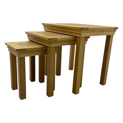 Contemporary light oak nest of three tables, each with rectangular top with moulded edge, raised on square supports