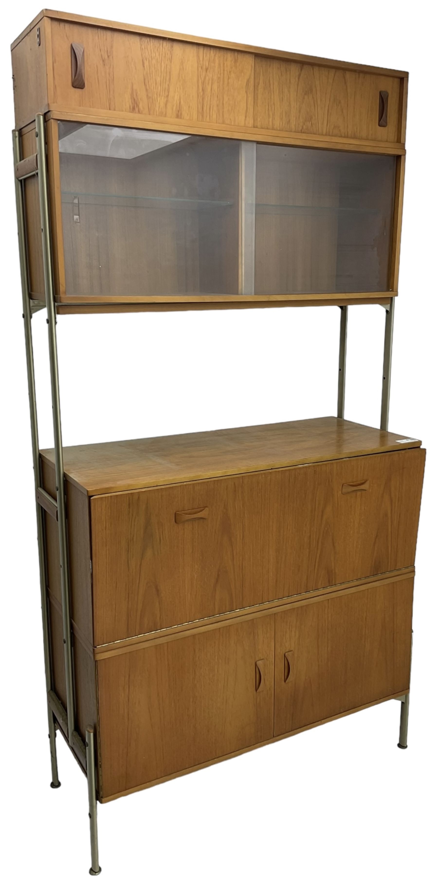 Remploy - mid-20th century teak sectional wall display unit or room divider, raised display cabinet section with sliding glass doors, central fall front section, lower double cupboard section and an additional sliding door section 