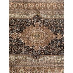 Large Persian indigo ground rug, the busy field decorated with trailing branches and flower heads, peach border decorated with palmettes -