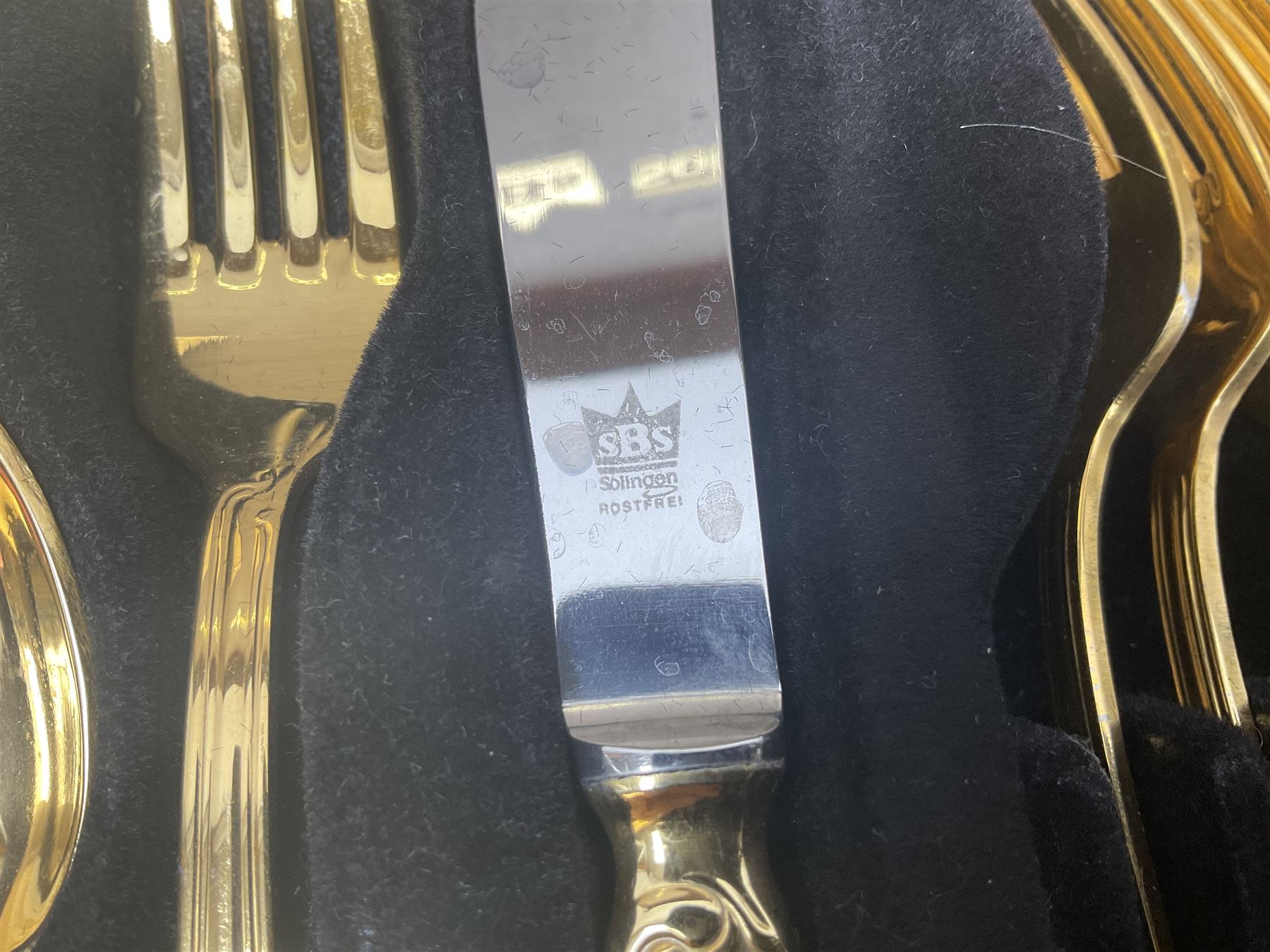 Bestecke Solingen canteen of gold plated cutlery for twelve place settings, including ladle, cake slice and serving spoons, contained within a briefcase, together with a matching set twelve of Bestecke Solingen gold plated fish knives and forks, in fitted case 