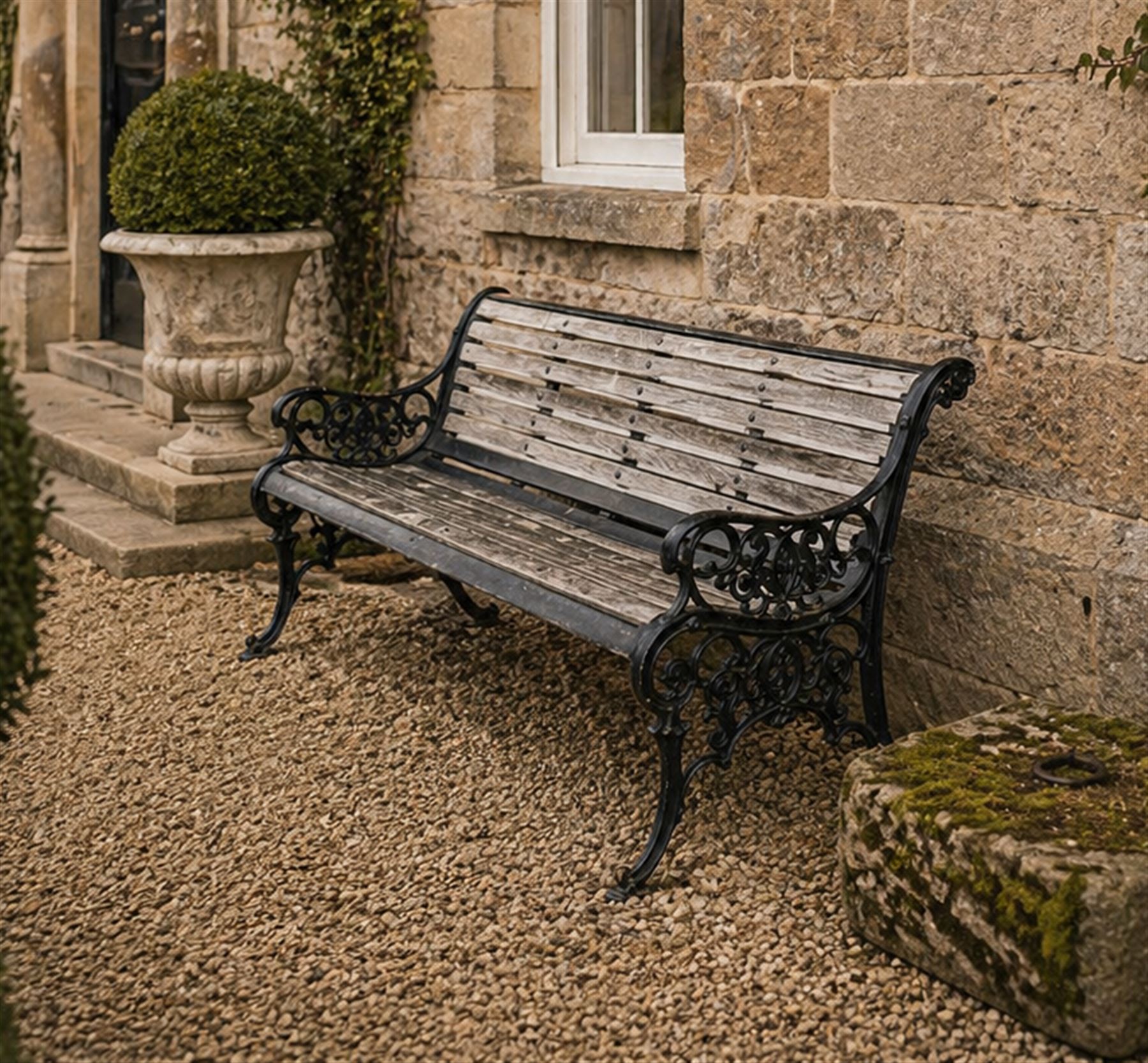 Victorian Andrew McLaren pattern cast iron bench, the ornate ends with detailed scrollwork, joined together with a cast iron seat and backrest frame supporting gently weathered oak slats, Victorian diamond stamp mark
