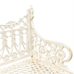 Victorian revival heavy cast iron garden bench, ornate back rest with scrolls, floral motifs and central crest, pierced lattice seat, curved arms and decorative legs, painted in antique white, in the Gothic Coalbrookdale style