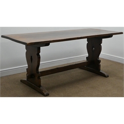  Titchmarsh and Goodwin oak refectory dining table, shaped and pierced solid end supports joined by single stretcher, sledge supports  