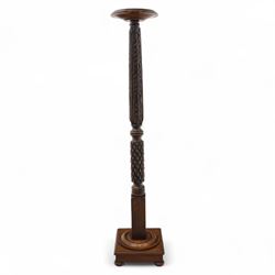 Late 20th century carved mahogany torchère stand, dished top above heavily carved column, with turned elements on moulded square base upon bun feet