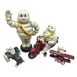 Collection of cast metal Michelin men, to include, one on a motor bike, come in a plane, one on a tractor and a large money box, money box H23cm