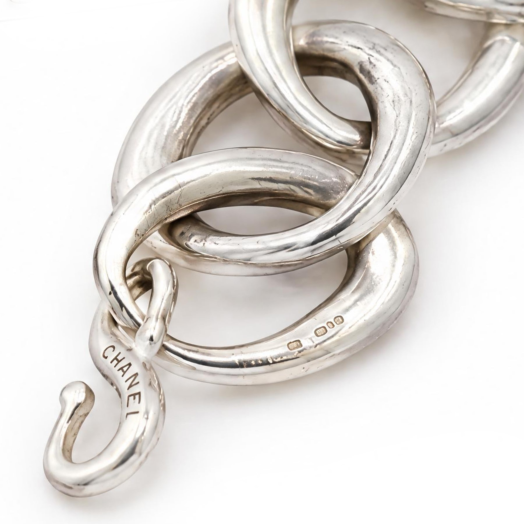Chanel silver bracelet, with ten oval interlocking links and a hook clasp, London 2000