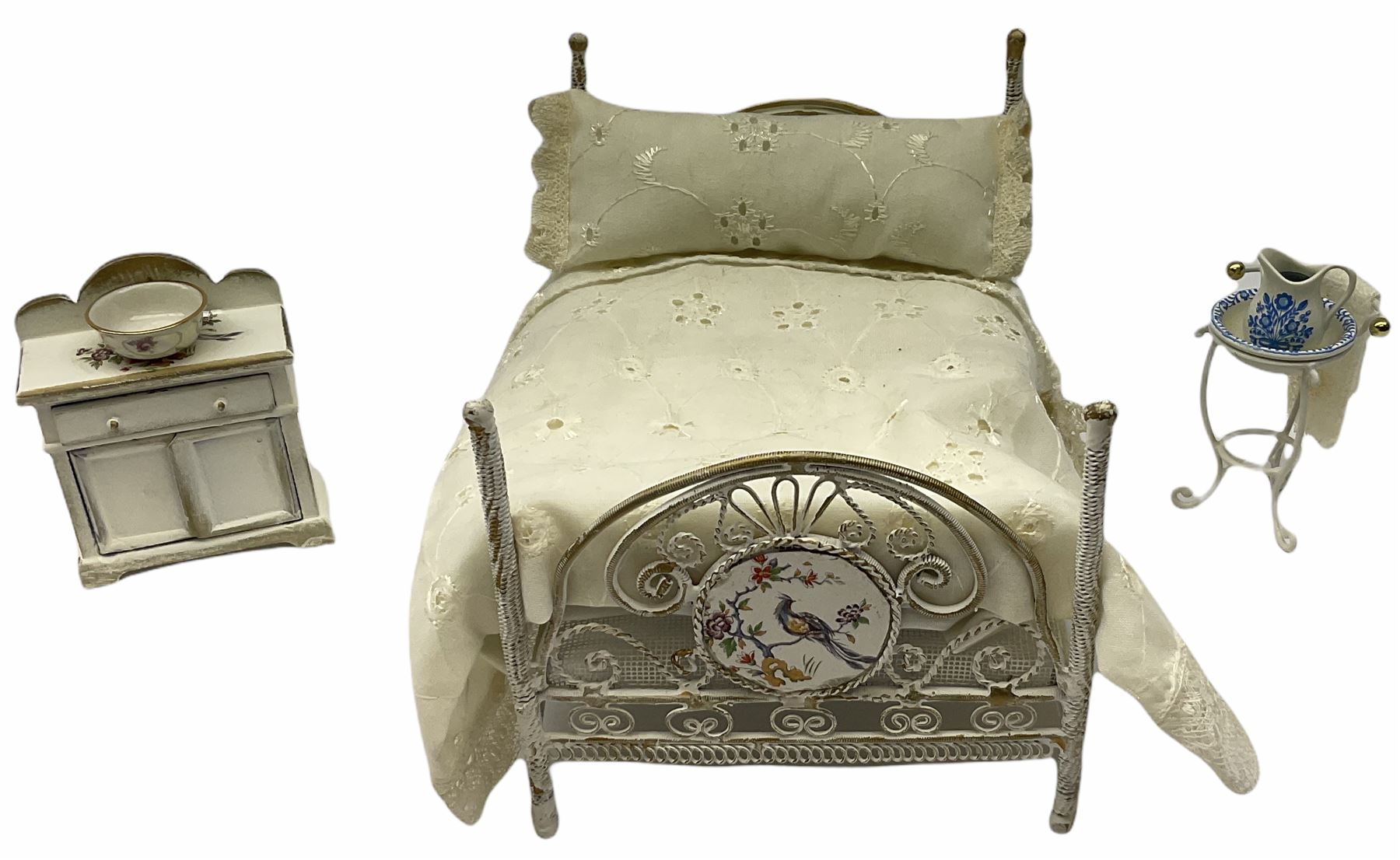 Georgian style wooden double fronted three-storey dolls house with pale blue stucco finish under a faux tiled roof with two chimney stacks, the double hinged front opening to reveal six fully decorated rooms with floor coverings, central staircase, porcelain fitted bathroom, kitchen with deep white sink and Aga cooker, electric lighting with adaptor, fully furnished with French style and other furniture, grand piano etc, and comprehensive range of accessories H82cm W61cm D31cm