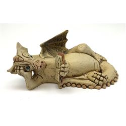 Zell Osbourne (British, Contemporary), Bookworm, a Studio Pottery figure modelled as a recumbent dragon with book, L21cm. 