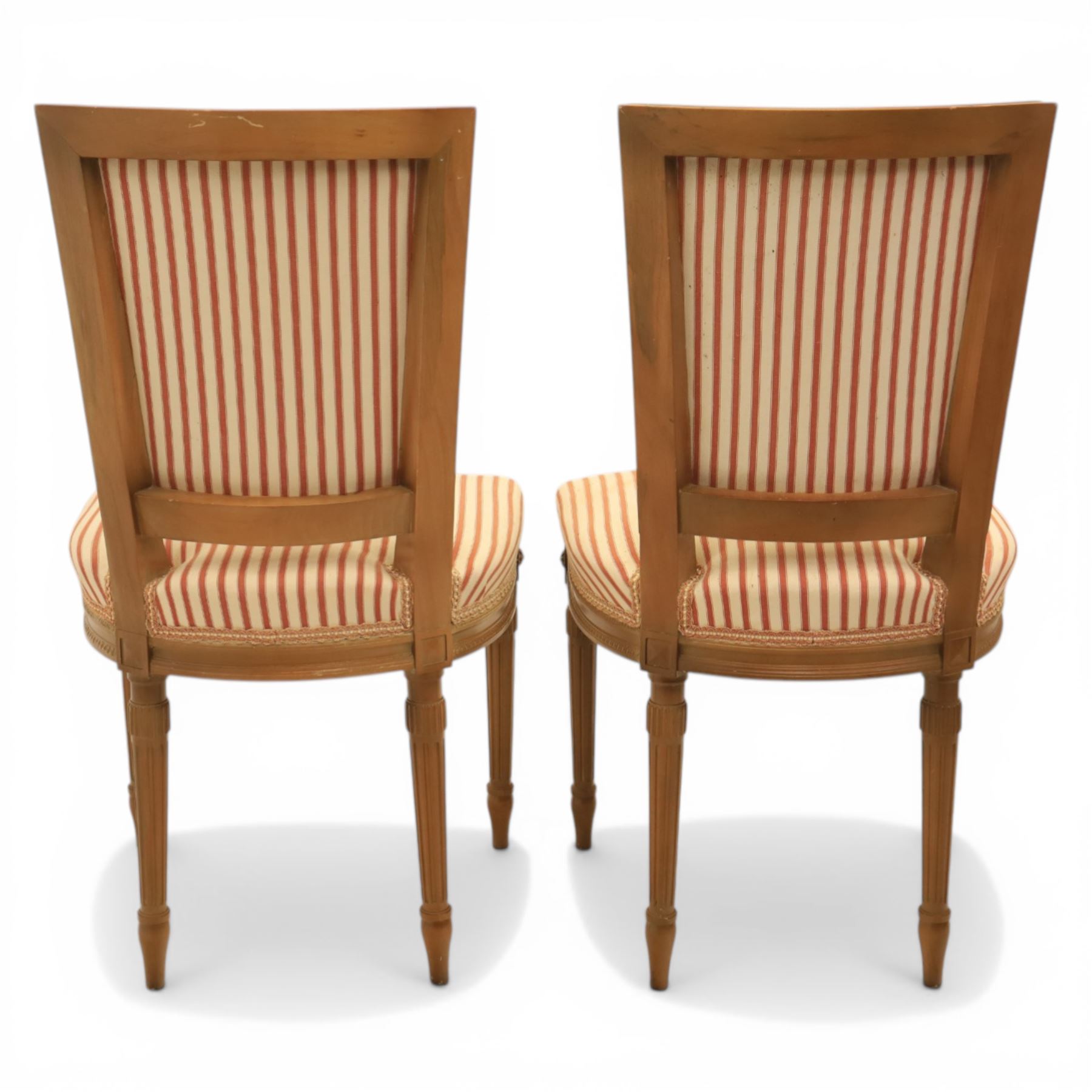 20th century Louis XVI style beech salon suite, comprising settee and four chairs, the settee with shaped rectangular back and upholstered arms over a shaped seat, the chairs with rectangular backs and overstuffed seats, each upholstered in striped fabric with close-nailed borders, upon fluted tapering supports headed by carved paterae, terminating in toupie feet, chairs H89cm W47cm