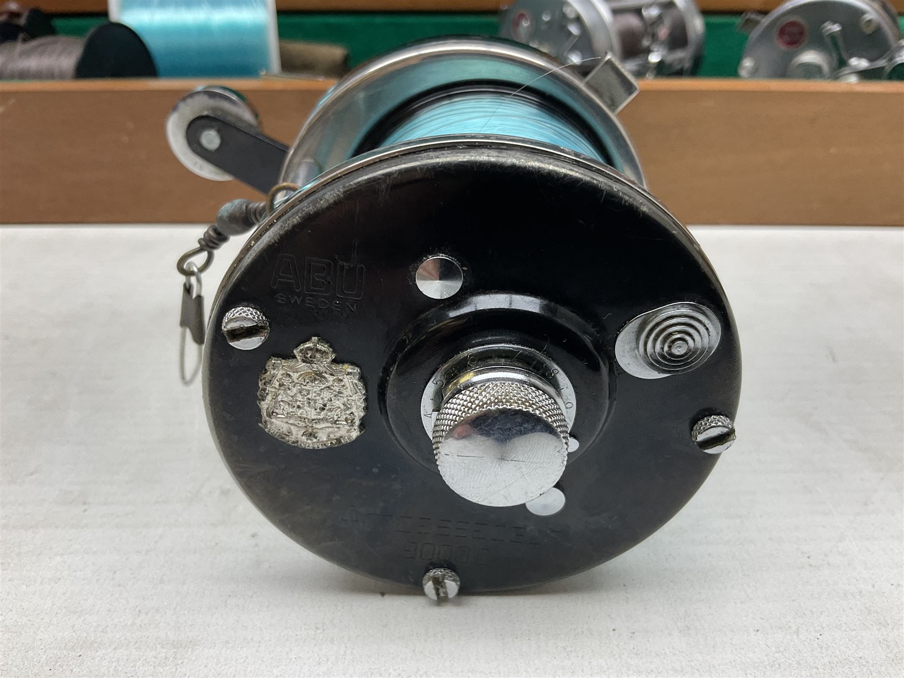 Four Abu fishing reels, comprising Ambassadeur 9000, Ambassadeur 7000, Ambassadeur 5500 and Ambassadeur 6500, together with additional line, hardy fishing bag and two wooden boxes