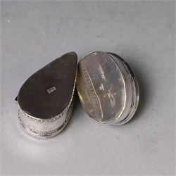 Two modern silver pill boxes, the first example of oval form, the hinged cover set with a tigers eye cabochon with beaded mount, and engraved scroll edge, hallmarked NC, London import 1995, W3cm, the second of teardrop form, the hinged cover set with lapis lazuli, marked 925, L3.5cm