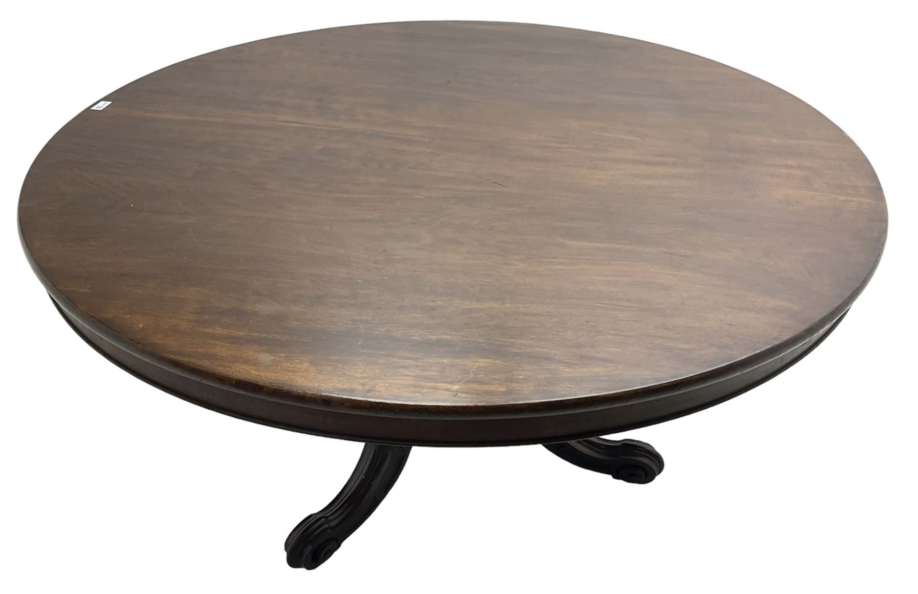 Victorian mahogany breakfast table, the circular tilt-top on carved pedestal, three moulded supports carved with bellflowers and scrolled terminals 