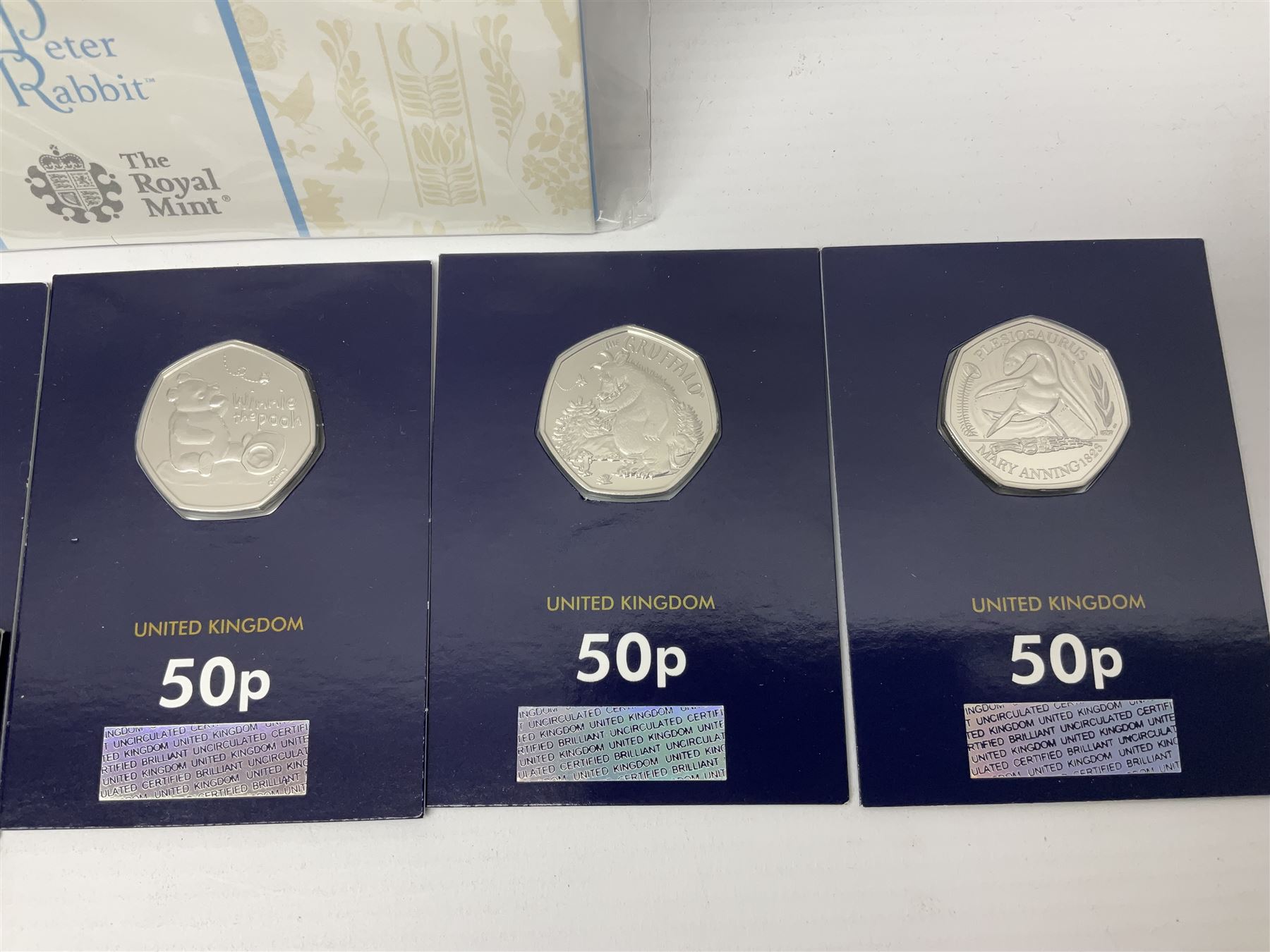 Mostly United Kingdom Queen Elizabeth II commemorative fifty pence coins, including 2019 'Gruffalo', 2020 'Iguanodon', 2022 'The Queen's Jubilee' etc, housed on cards, face value of UK coins approximately 20 GBP