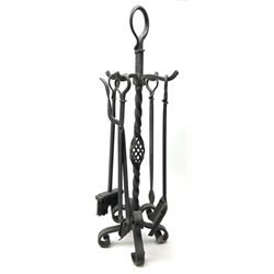 A cast iron fire tool set, with decorative twisted stand, 87cm.  