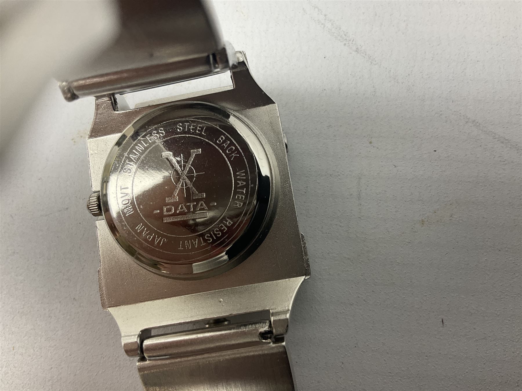 Four X Data stainless steel wristwatches, two Marc Gay wristwatches and one other, all with cover plates