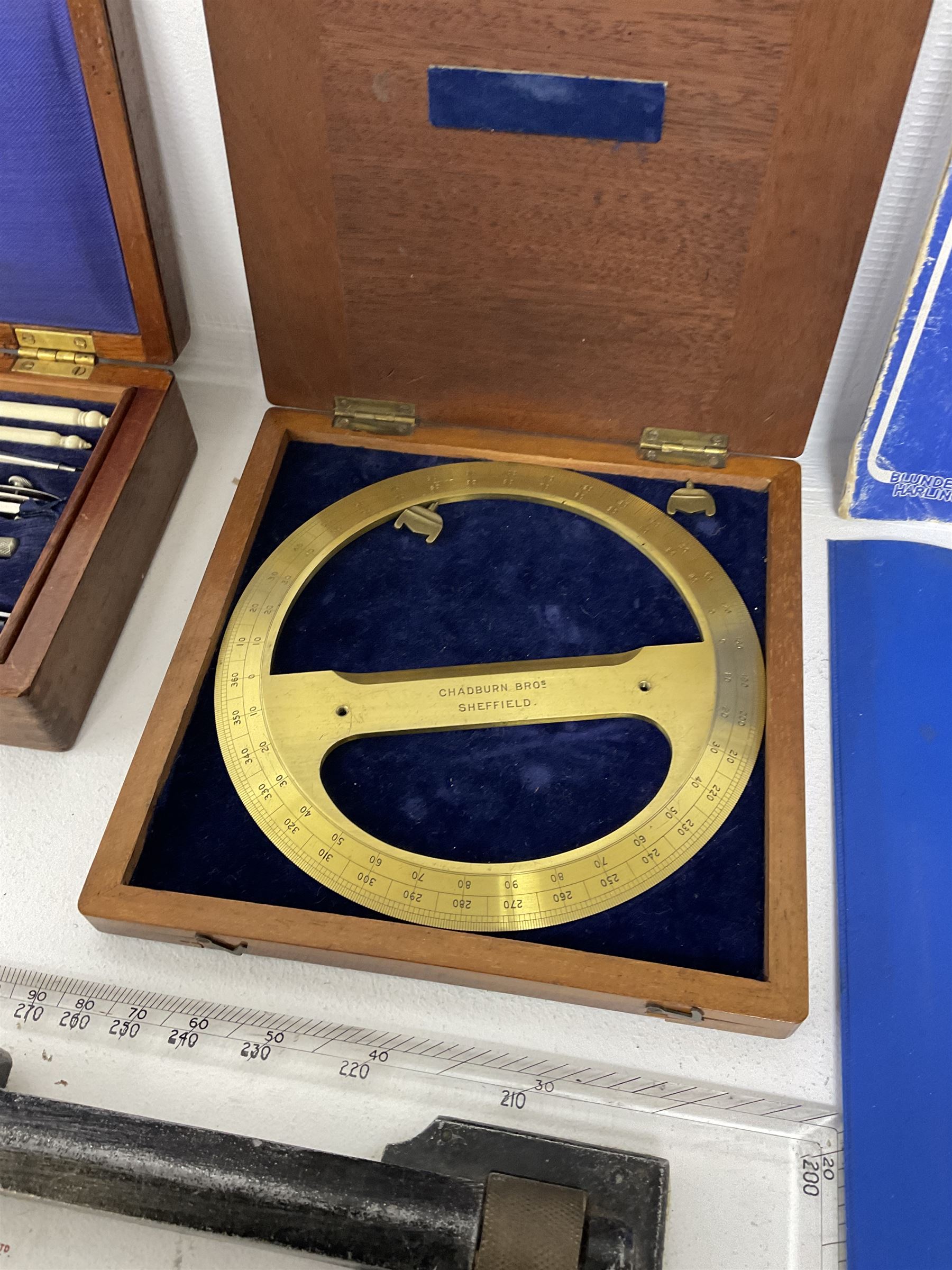 Brass 360 precision drafting protractor by Chadburn bros, in mahogany case, A G Thornton Drawing instruments in a mahogany case, together with P.I.C slide ruler, Nautical protractors etc 