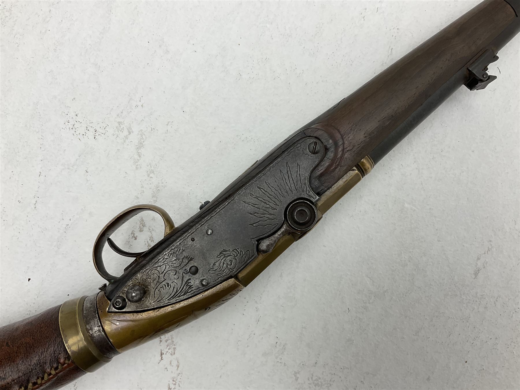 Late 18th century 7.2mm (approx. .28 calibre) Girandoni system single shot reservoir air rifle, the 62cm steel barrel with swivelling two-leaf rear sight, brass breech decorated with a sunburst and lever opening top loading, engraved steel lock-plates marked 'S. Gaskell' to the right side underneath the cocking lever, brass trigger guard,  leather covered steel butt reservoir of tapering conical form with brass ferrule and walnut fore-stock with horn mounts L107cm overall