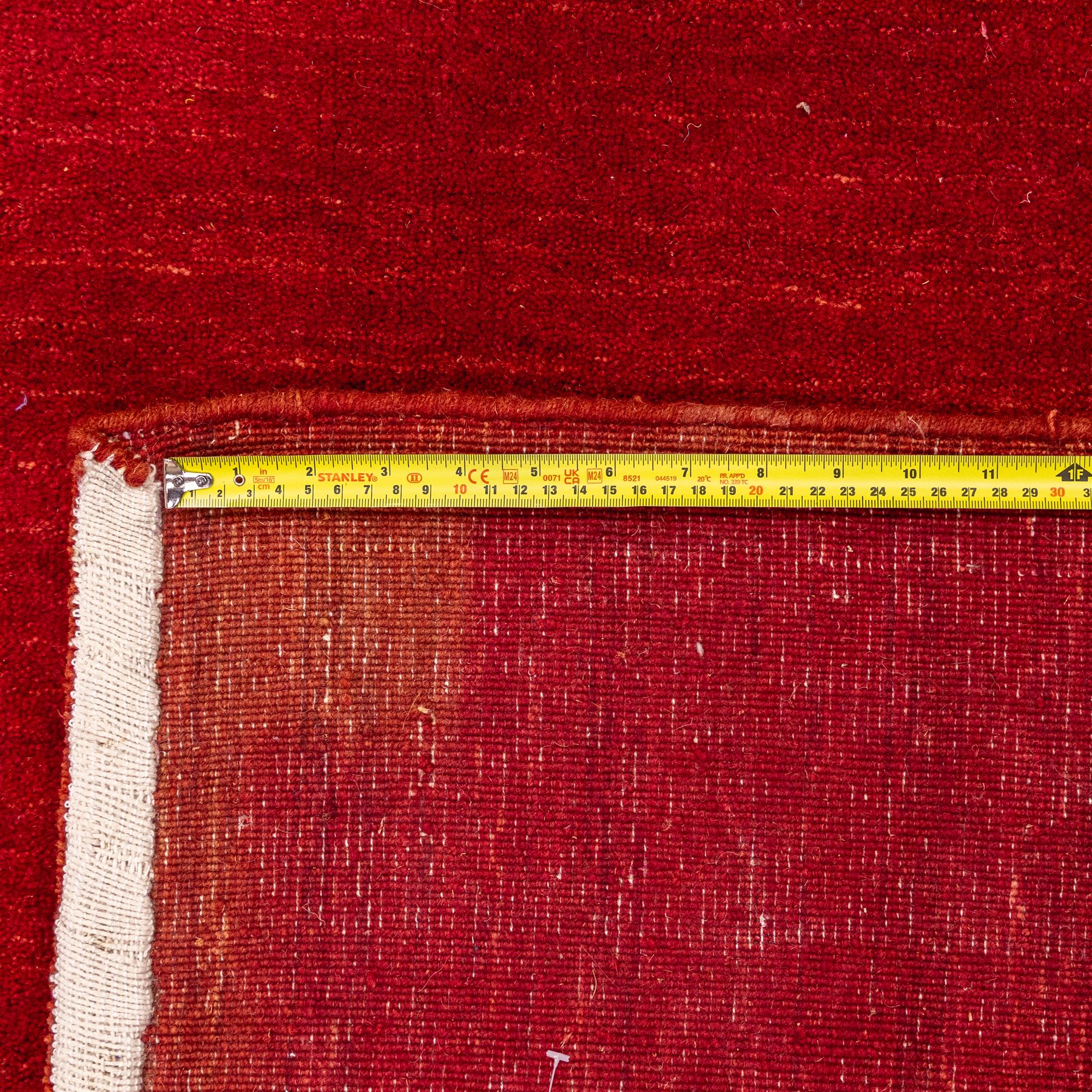 Indian hand-knotted wool Gebbeh design carpet, of rectangular form, woven in a rich madder red tone