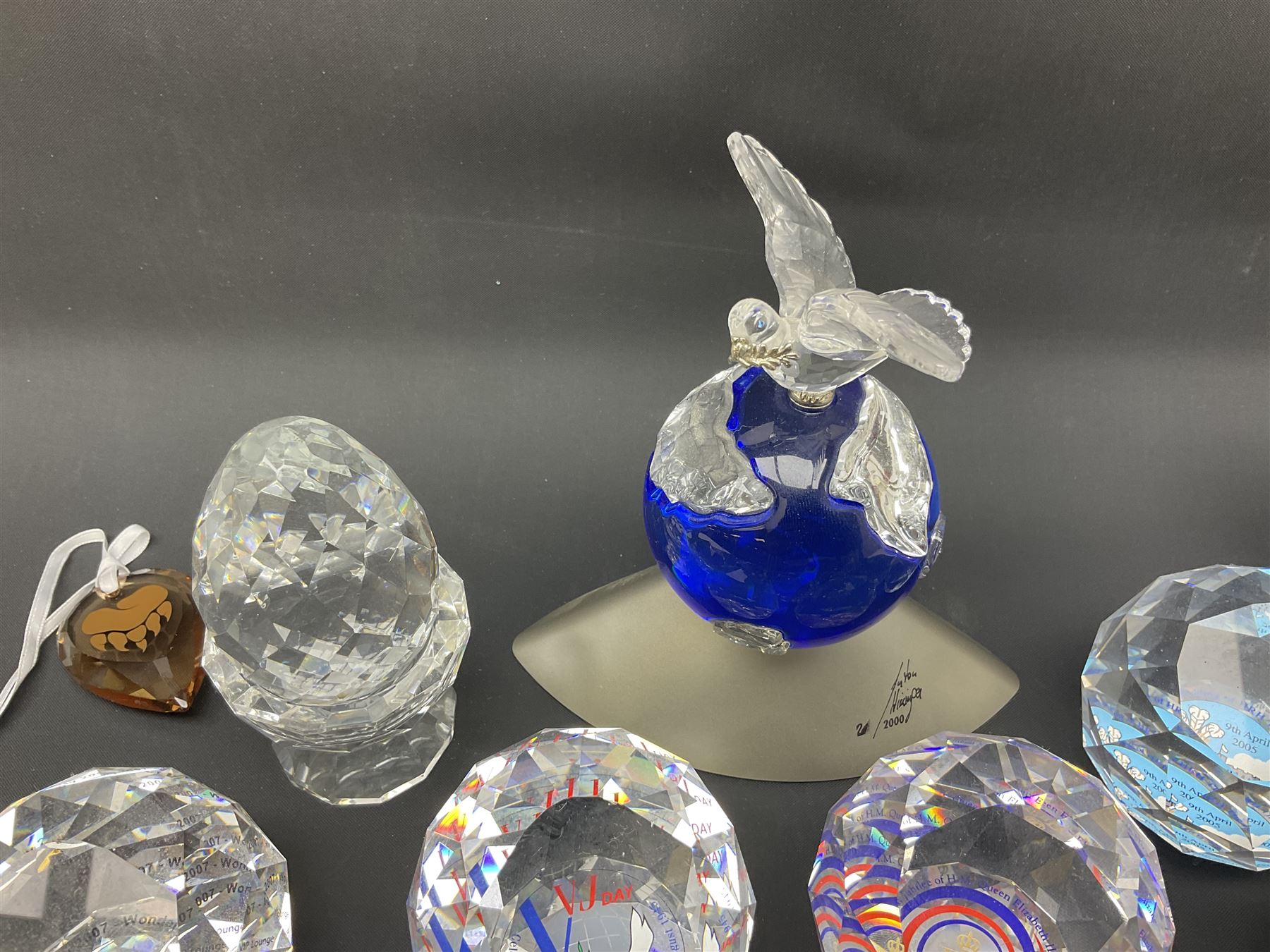 Swarovski Crystal paperweights, to include a globe with dove to the top, pyramid shapes etc, together with a large collection of boxes and stands  
