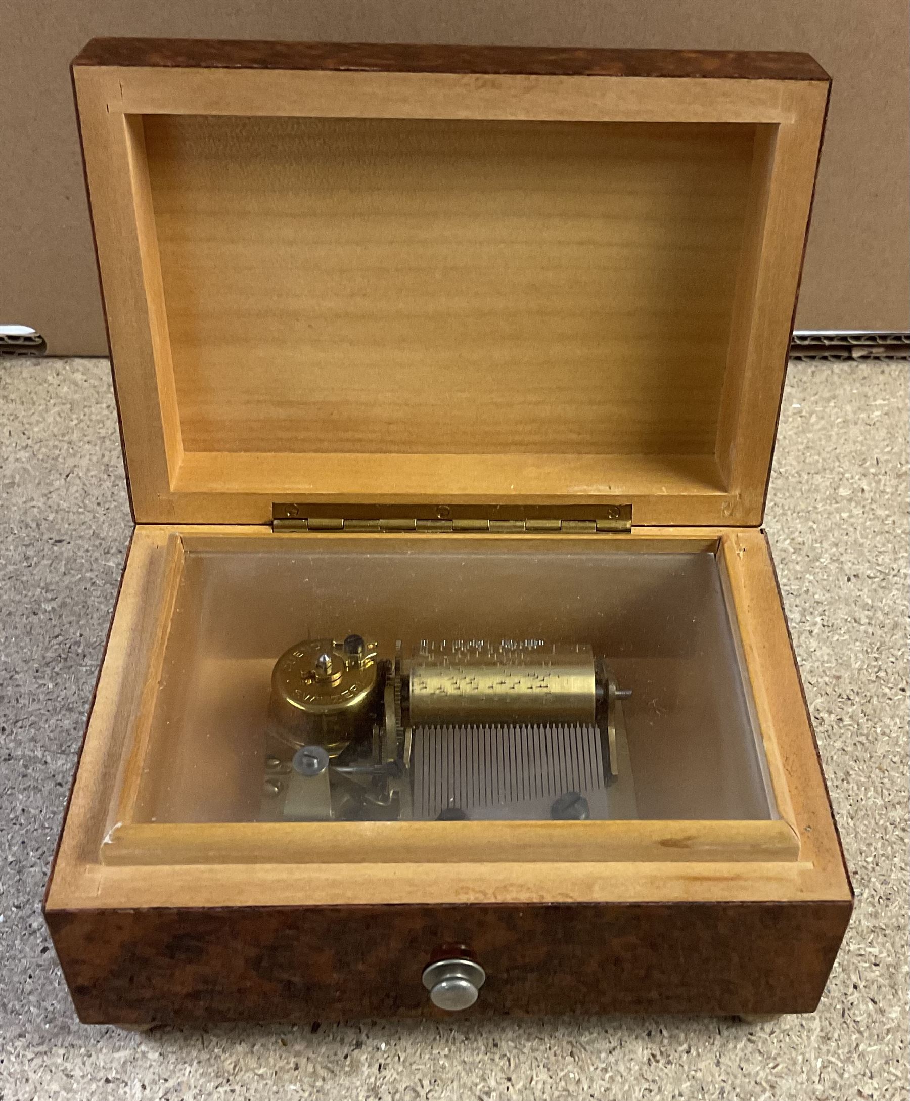 20th century burr wood Swiss musical box, marbled beneath 'made in Switzerland', paper label inscribed 'Around the world The Lass of Richmond Hill', H6.5cm W12.5cm D9cm