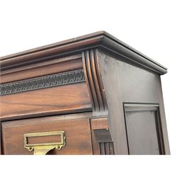 The Shannon Limited - late Victorian walnut filing cabinet, fitted with twenty-four small filing drawers, each with brass handle with label holder, fluted uprights, double cupboard below enclosed by two panelled doors, on turned feet, with brass plaque inscribed 'The Shannon, Limited, Ropemaker St. London, E.C.'
