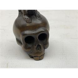 Netsuke in the form of a rat sitting on a skull, signed to the base