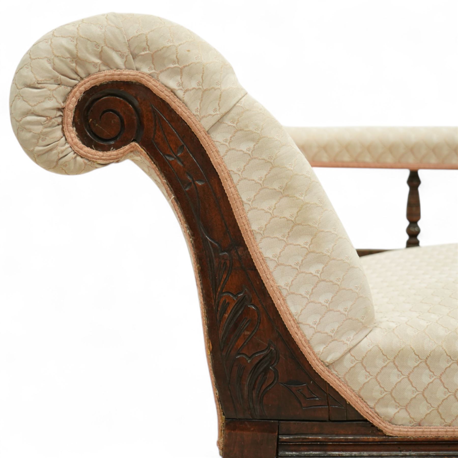 Late 19th century cream upholstered chaise longue, patterned pale damask fabric, padded arm with spindle back gallery raised on turned legs upon castors