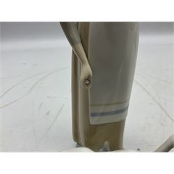 Seven Lladro figures, comprising Playful Puppy no 9135, Platero and Marcelino/Boy Hugging Donkey no 1181, Mini Seal Family no 5318, Attentive Polar Bear no 1207, Seated Polar Bear no1209, Eskimo Boy with Pet no 5238 and Girl with Geese no 1035, together with Nao goose