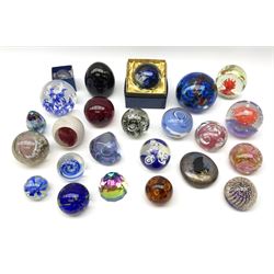 A group of assorted paperweights of various size and design, to include red example with controlled bubble decoration marked Whitefriars, examples with internal 'flower' decoration, etc. (24). 