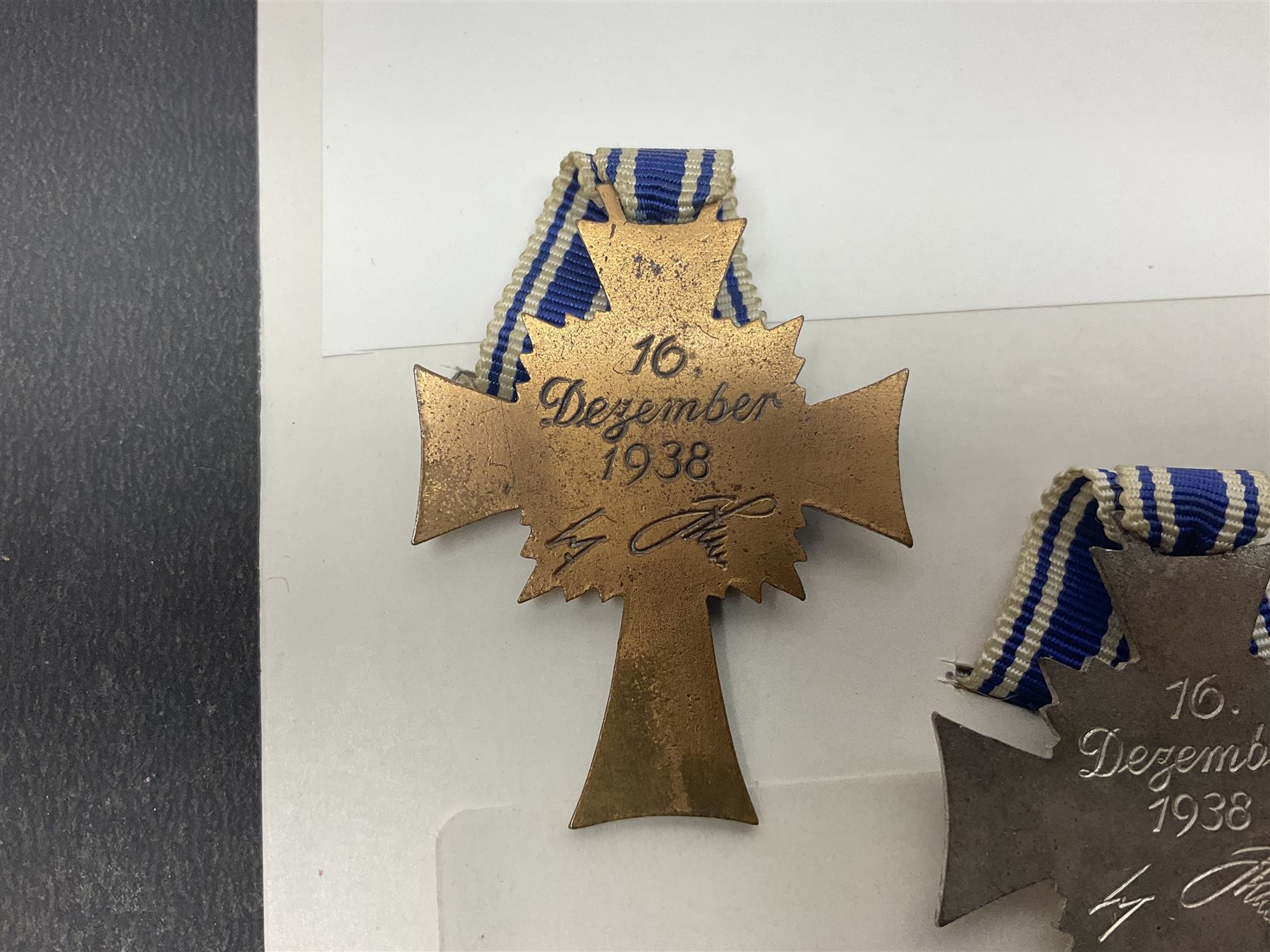 WWII set of three German Mother's Crosses, 1st Class in gilt, 2nd Class in silver and 3rd Class in bronze; all with ribbons (3)