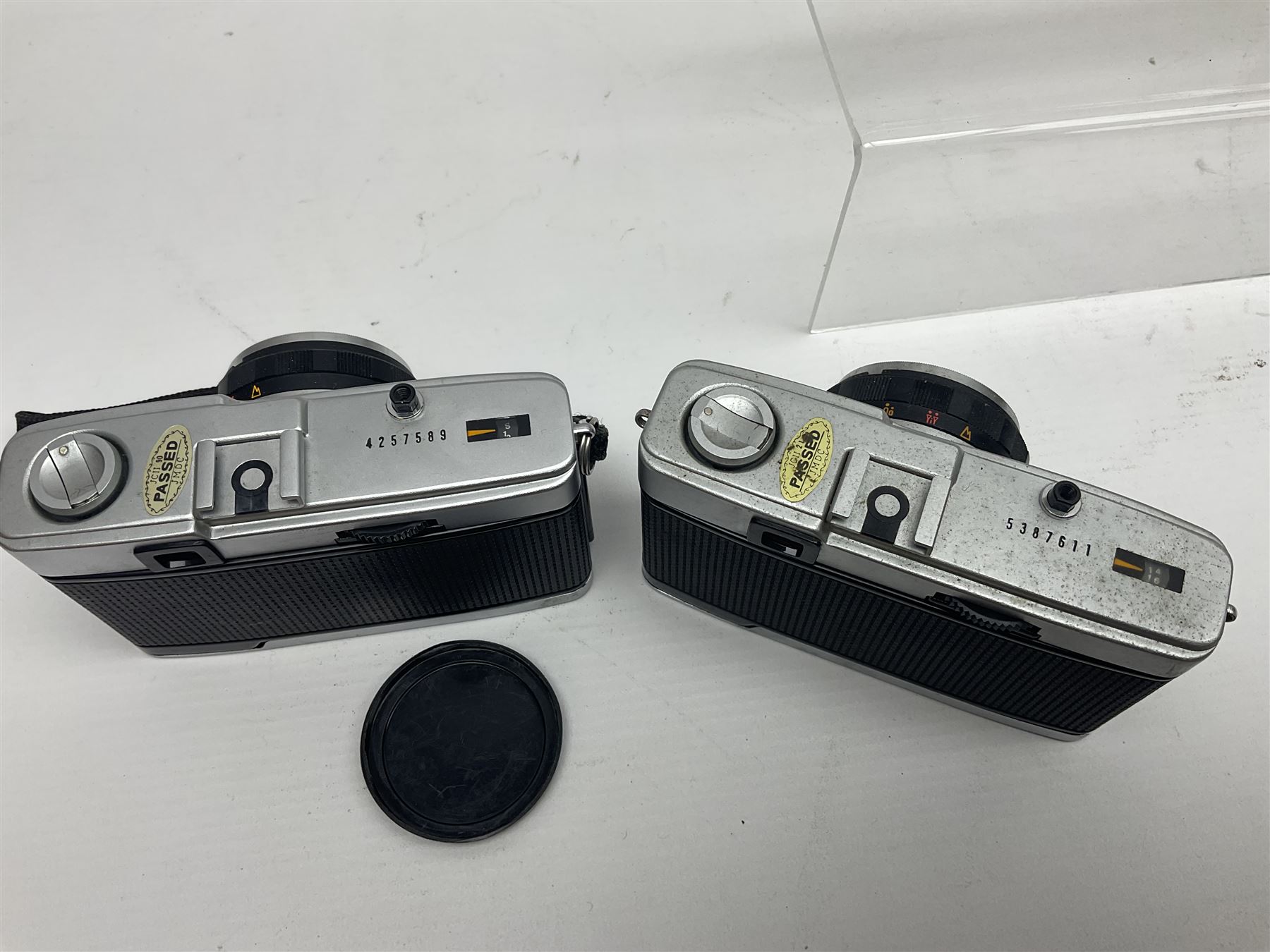 Olympus Pen-EE camera, serial no 415299, with Olympus D.Zuiko 1:3.5 f=2.8cm lens, together with four Olympus Trip 35 cameras, serial nos 4759245, 4257589, 1847727 and 5387611, each with Olympus D. Zuiko 1:28 f=40mm lenses