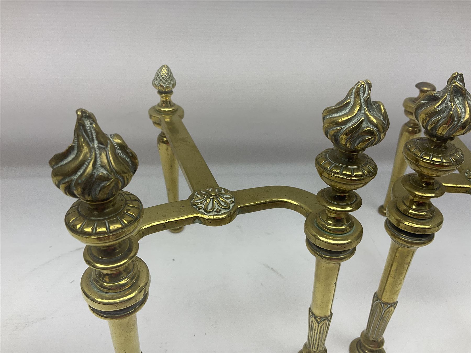 Early 20th century brass coal bucket with pierced sides, upon three pad feet, together with a pair of brass fire dogs, with flambe finials, coal bucket H27cm