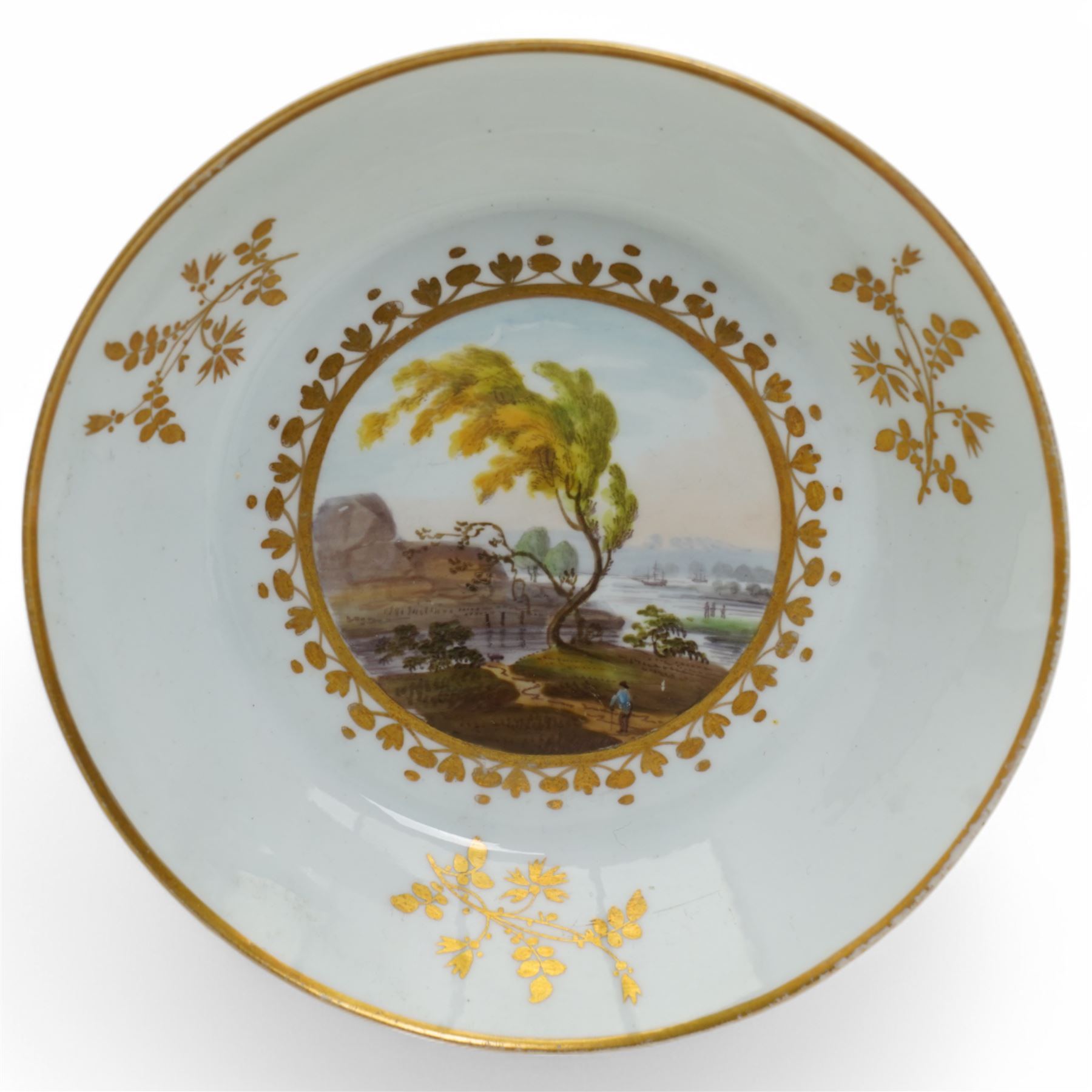 19th century teacup and saucer, possibly Coalport, decorated with panels of flowers on a cobalt blue ground with gilt decoration; together with two other teacup and saucer pairs, one with hand painted landscape decoration 