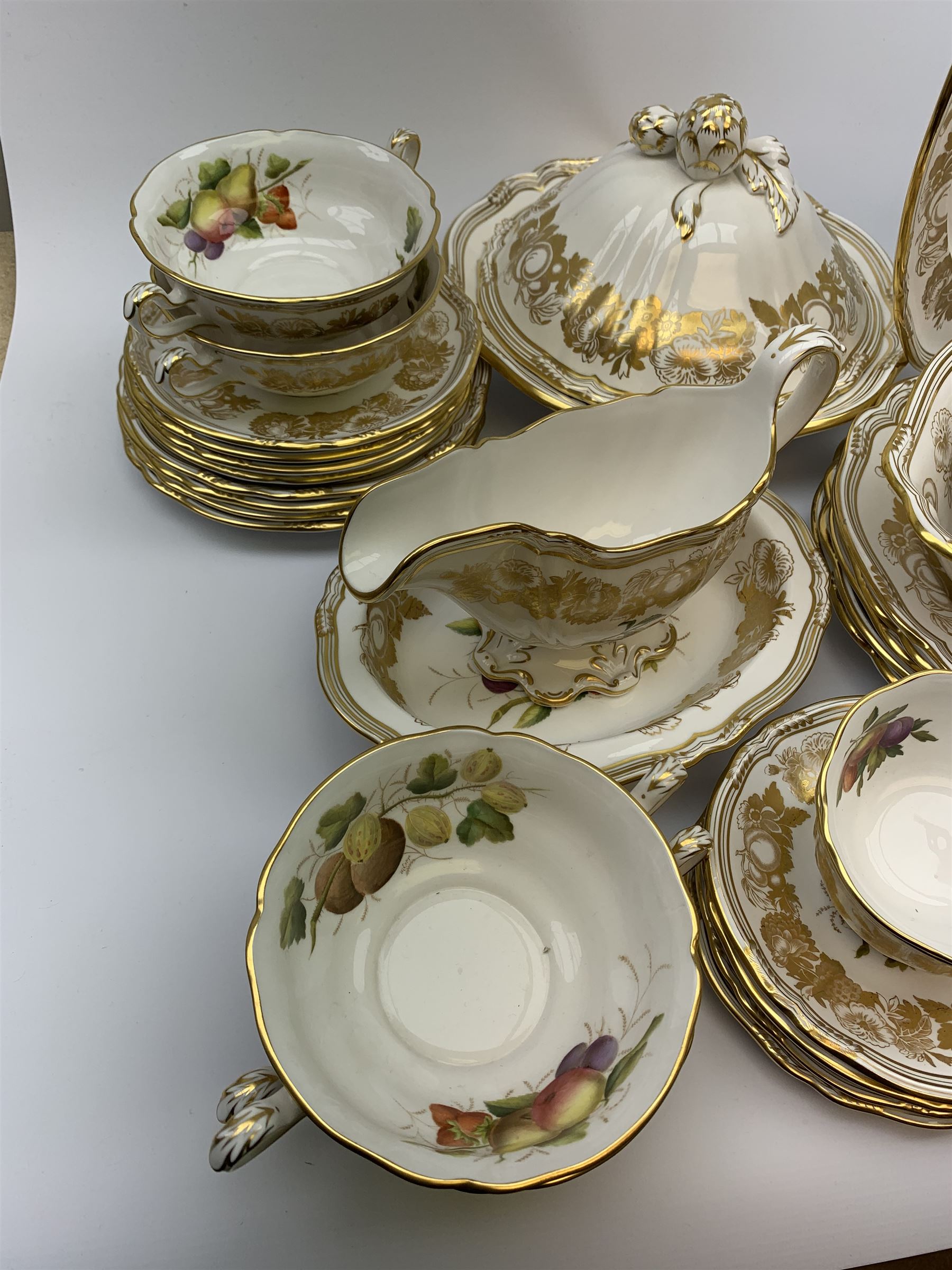 Extensive Spode dinner and tea service, decorated in the Golden Valley pattern, comprising eighteen dinner plates, ten salad plates, ten side plates, ten twin handled soup bowls and ten saucers, ten bowls, two sauce boats and two stands, two square serving dishes, smaller oval serving dish, two tureens and covers, two large oval serving platters, one smaller example, teapot, coffee pot, milk jug, twin handled lidded sucrier, and ten teacups and ten saucers, with red printed marks beneath 