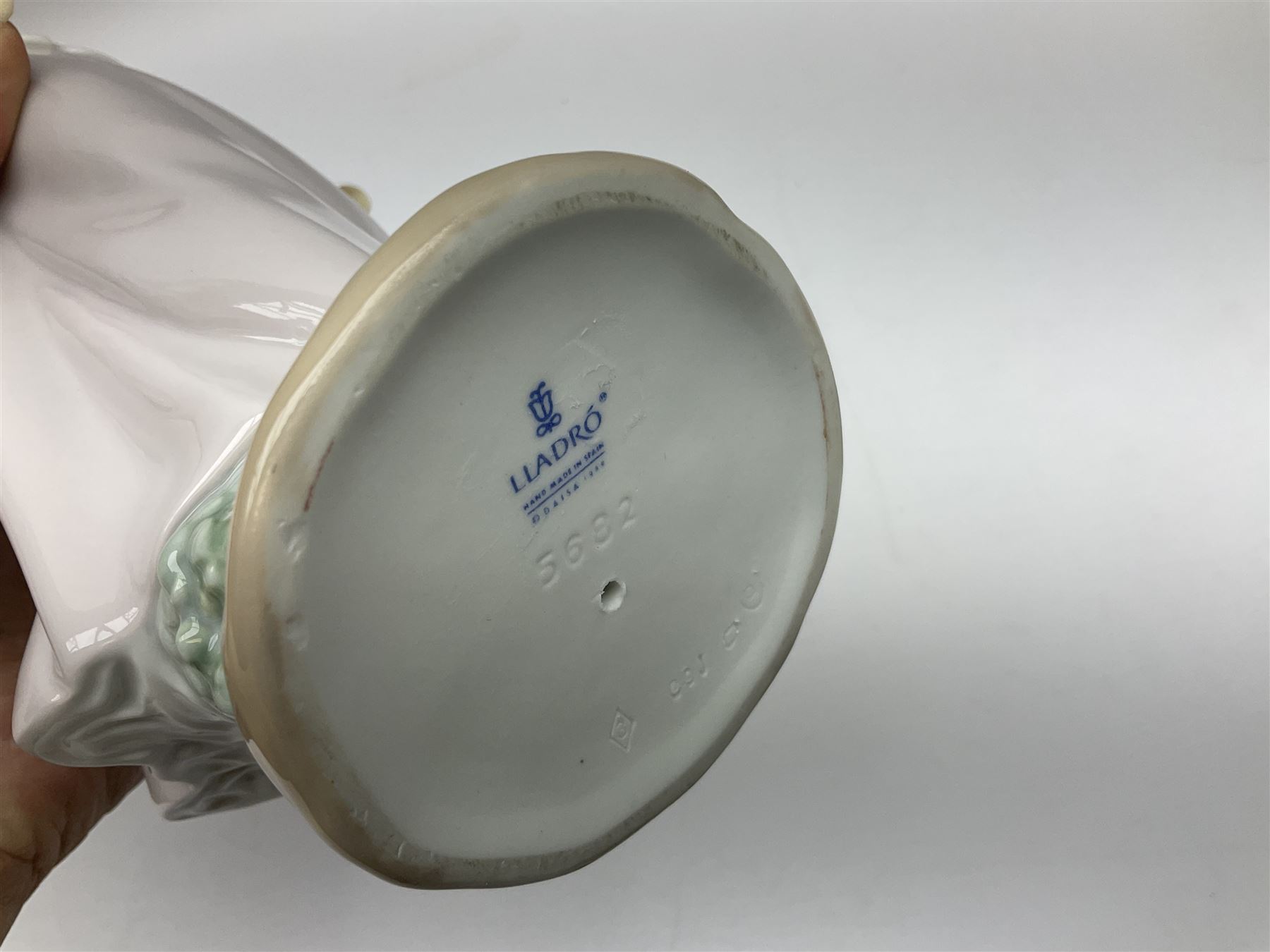 Three Lladro figures, comprising, Dreams of Summer Past no 6401, Spring Breeze no 4936 and Breezy Afternoon 5682 together with Lladro plaque Art Brings us Together no 7677, all in original boxes, largest example H35cm