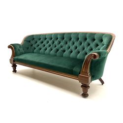 Victorian mahogany settee, upholstered in green buttoned fabric, moulded frame and scroll carved arm terminals, turned supports