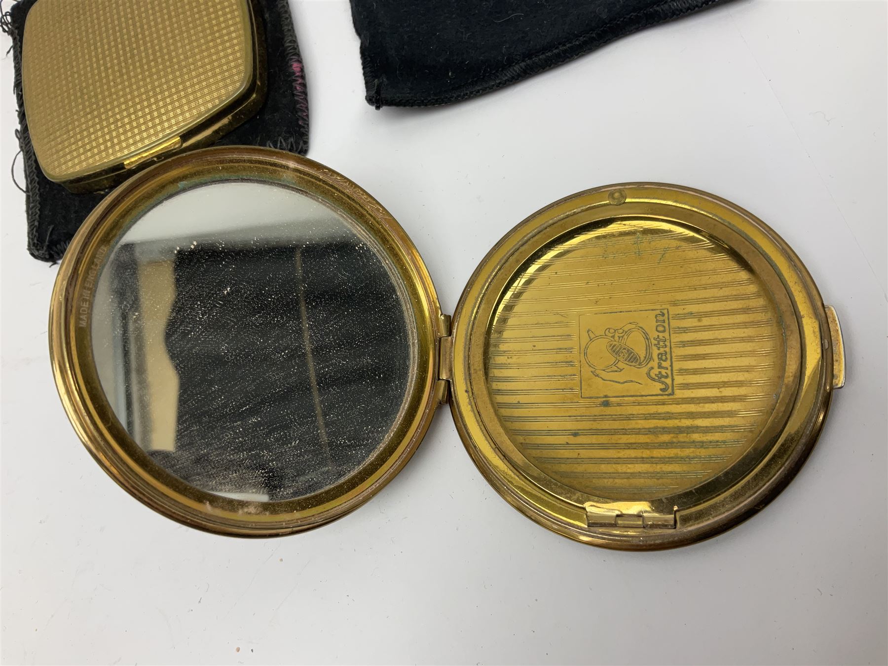 St Dupont gold plated cigarette lighter, with engine turned decoration, serial no EW1279, together with three powder compacts, including Stratton and Regent of London examples