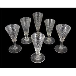 Four late 18th/early 19th century short ale drinking glasses, the wrythen twist trumpet bowls upon short knopped stems and circular feet, one folded, together with a pair of 19th century drinking glasses with part honeycomb moulded trumpet bowls, upon stems with collars and circular feet, each approximately H14cm