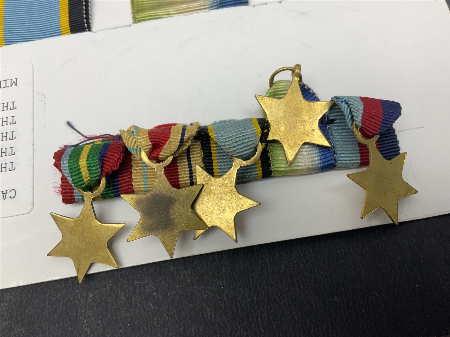 Representative display of WWII Campaign stars comprising 1939-1945 Star, Atlantic Star, Air-Crew Europe Star, Africa Star and Pacific Star; together with the corresponding group of miniatures; all with ribbons