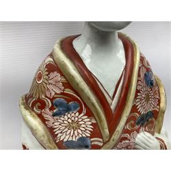 Large Japanese Imari porcelain figure, modelled as a Bijin, wearing a long kimono decorated with apple blossom and leafy branches on a white ground, with gilt detailing, possibly Edo period, H63cm