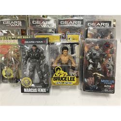 Sixteen carded action figures comprising seven 'Gears of War'; four 'Hitchhikers Guide to the Galaxy'; two 'Torchwood'; 'Planet of the Apes'; 'Bruce Lee'; and 'Assassin's Creed'; all in unopened packs (16)