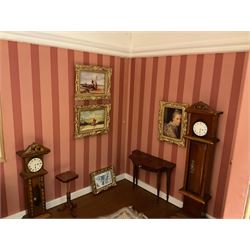 Good quality late 20th century dolls house by M. James dated 1995 in the form of a Beverley East Yorkshire Antique Shop called 'North Bar Antiques'; single-storey single-roomed shop with textured brick walls and flat roof, fully glazed hinged front with recessed hinged customer door and central window to the rear; comprehensively furnished with chests of drawers, pedestal desk, breakfast table, lowboy, two longcase clocks, delft rack with ceramics, occasional tables, pictures, Regency style mirror and collectibles; decorated walls with coving and picture rail and simulated floorboarding; wired for electric lighting; maker's plaque W61cm H42.5cm D41.5cm