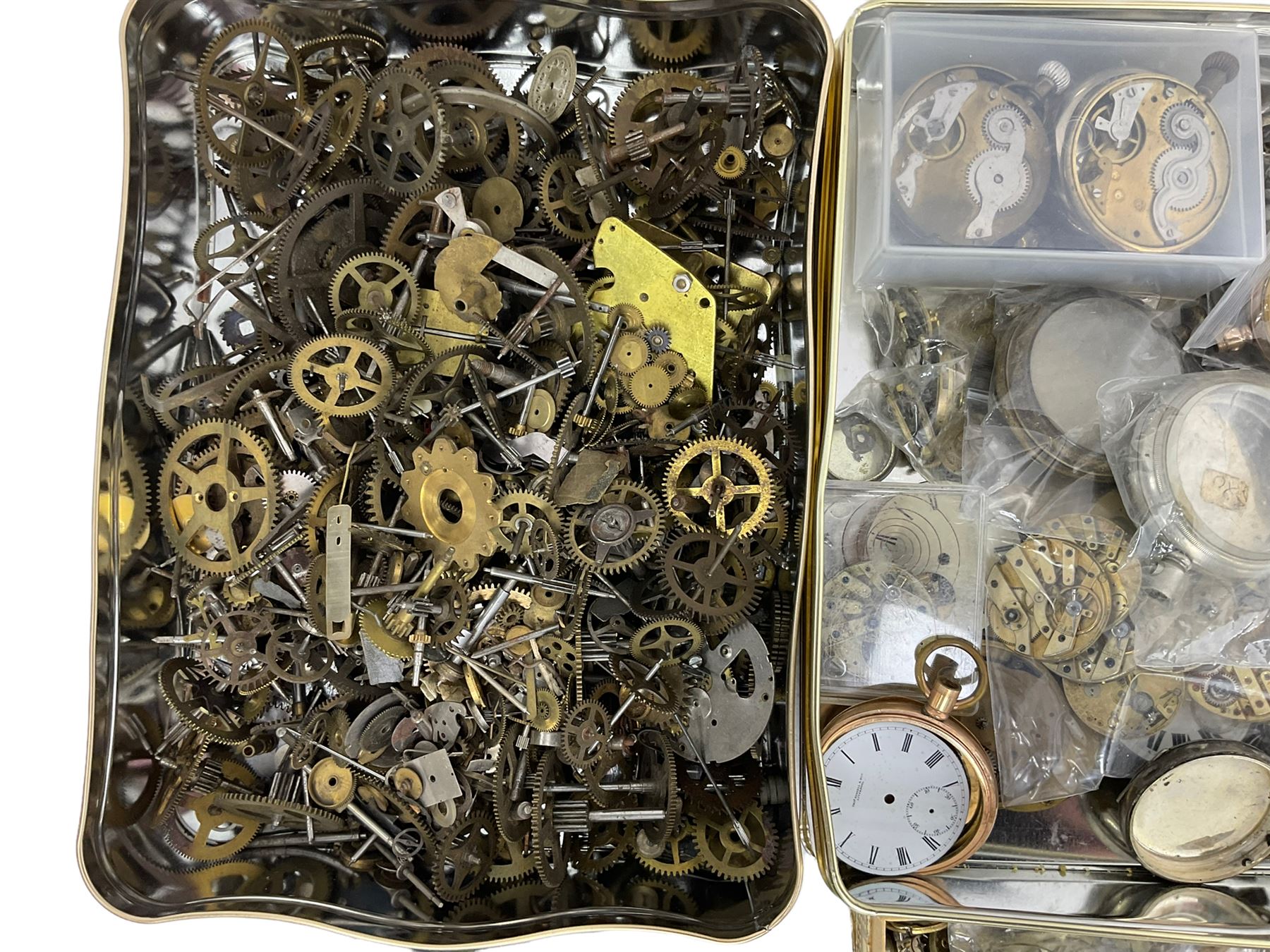 Large selection of dismantled clock wheels and pinions, watch movements