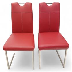 Set of seven contemporary style dining chairs, each with a high padded back and seat upholstered in faux leather on brushed steel sled bases  