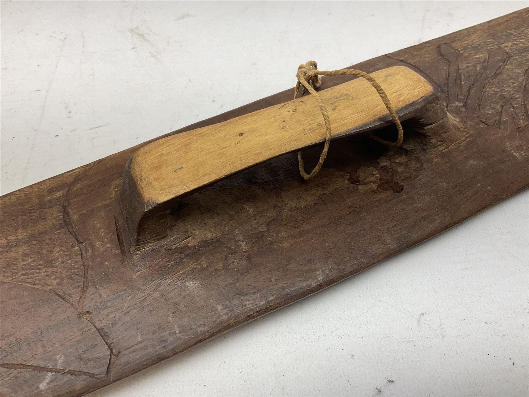 Australian Aboriginal shield, carved with Kangaroo and Emu, 74.5cm; Spear painted with aquatic creatures 78cm, and Spear thrower 81cm (3)
