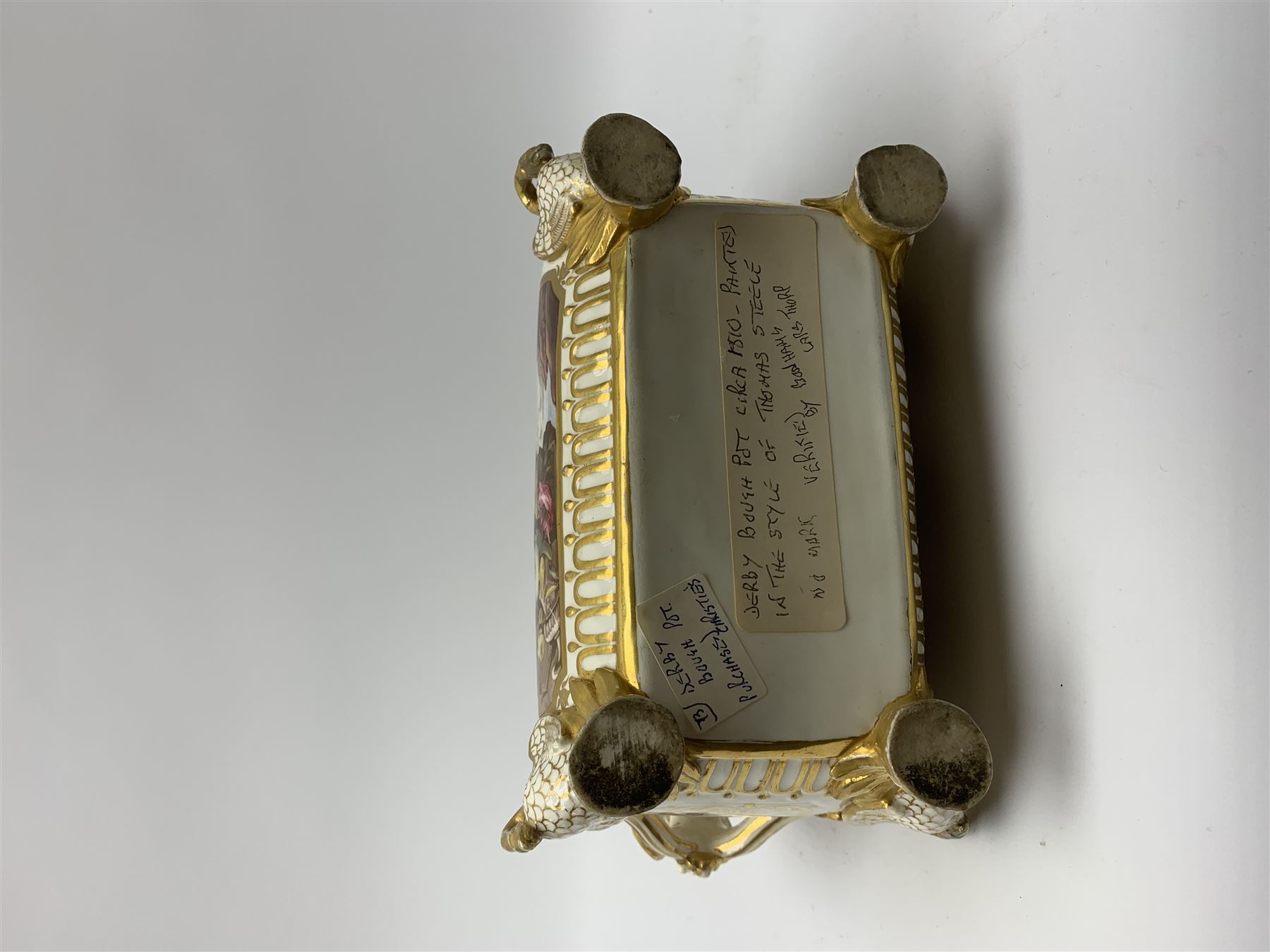 19th century Coalport bough pot, circa 1820, of bombe form, the body with twin handles surmounted by two birds and raised upon four feet modelled as swans, hand painted with two panels depicting an urn of flowers set against a mountainous landscape, the whole heightened in gilt throughout, H13cm L21cm