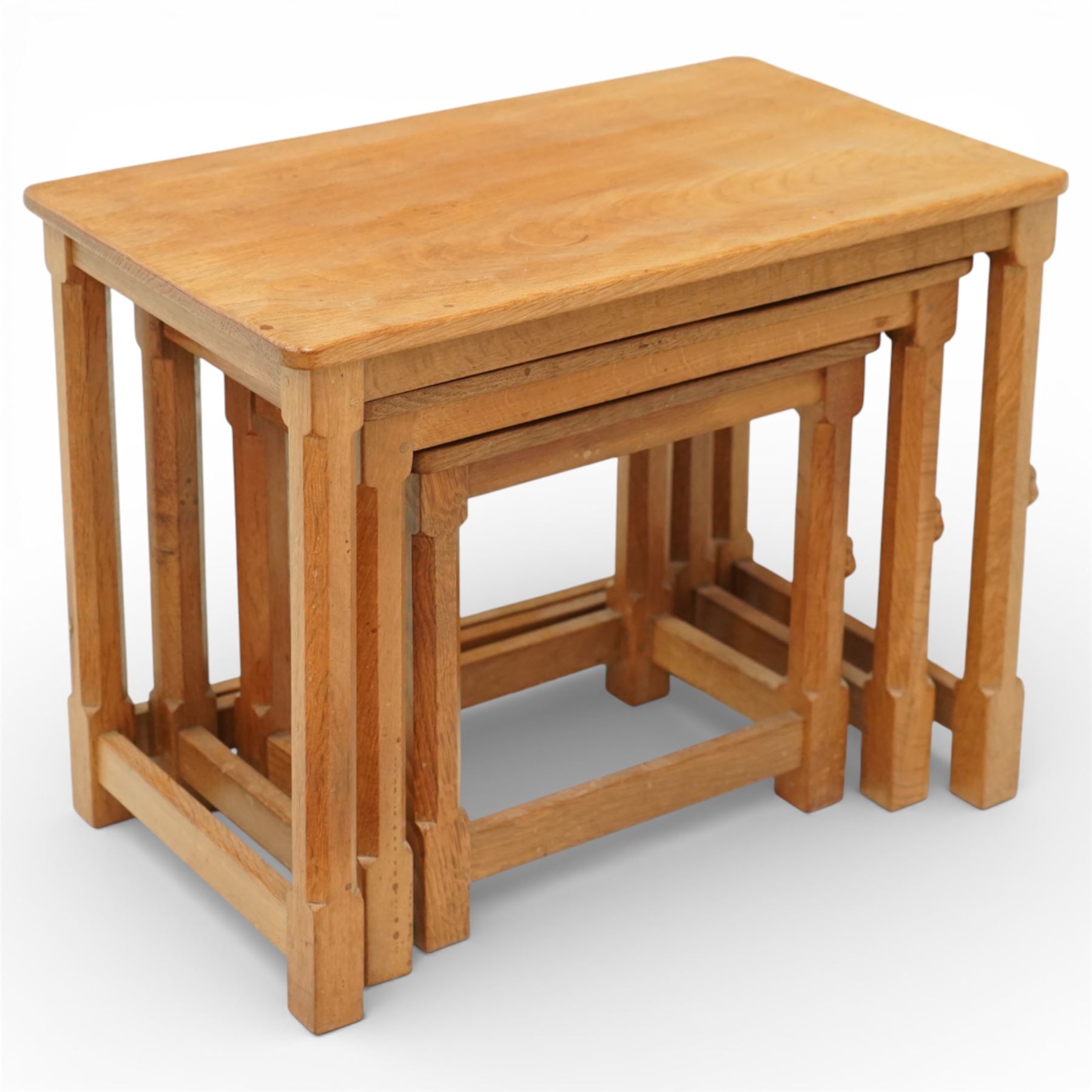 Mouseman - oak nest of three tables, raised on octagonal supports, with carved mouse signature, by the workshop of Robert Thompson of Kilburn