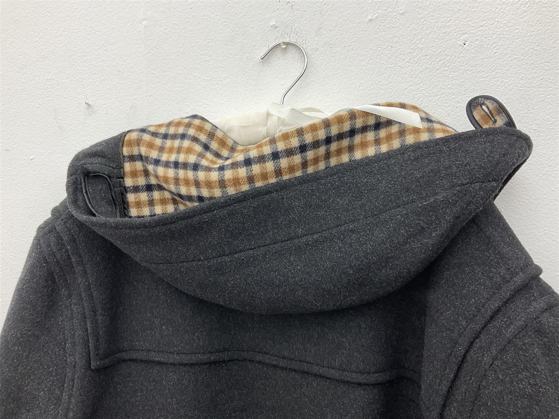 Men's Aquascutum lambs wool herringbone tweed coat with silk lining, 46 Reg, together with a further Men's Aquascutum grey wool duffle coat, with cheque lining and horn buttons, 46