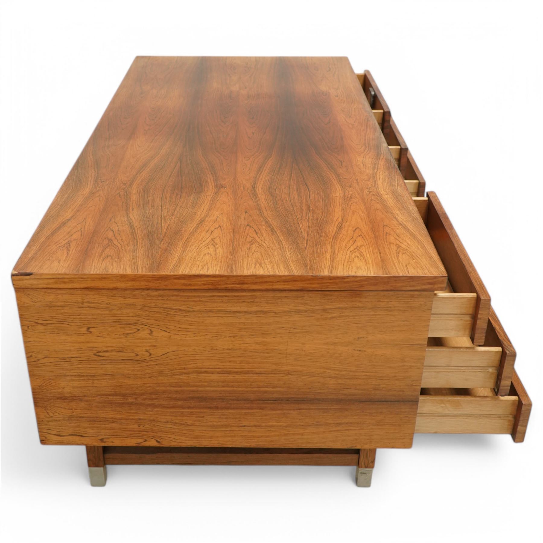 Mid-20th century rosewood pedestal desk, the rectangular top above twin pedestals each fitted with three drawers, all with recessed metal pulls, raised on square legs with stretcher supports and capped metal feet